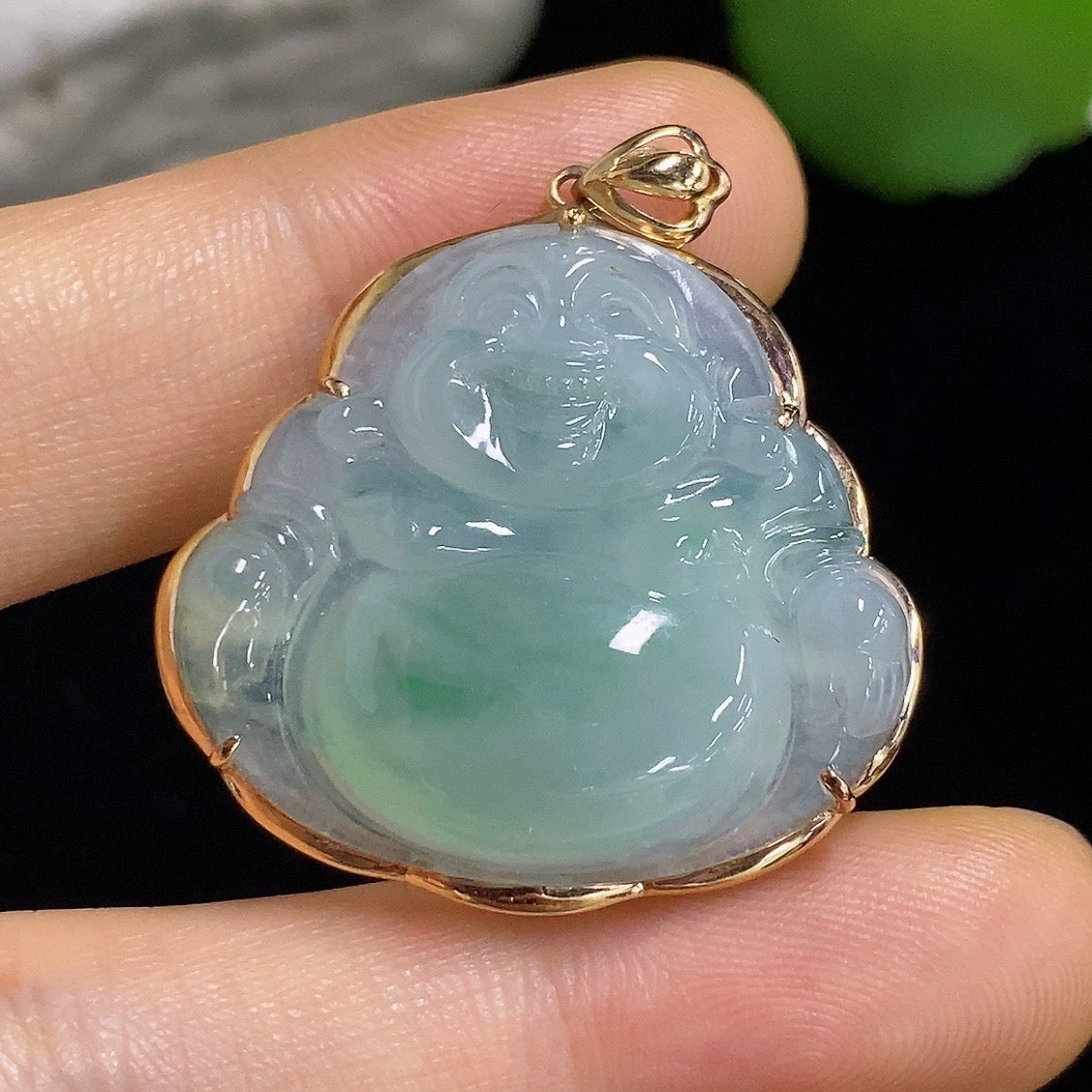 Jadeite Buddha pendant with 18k gold mounting, featuring a carved jade Buddha figure, weighing approximately 6.31g.