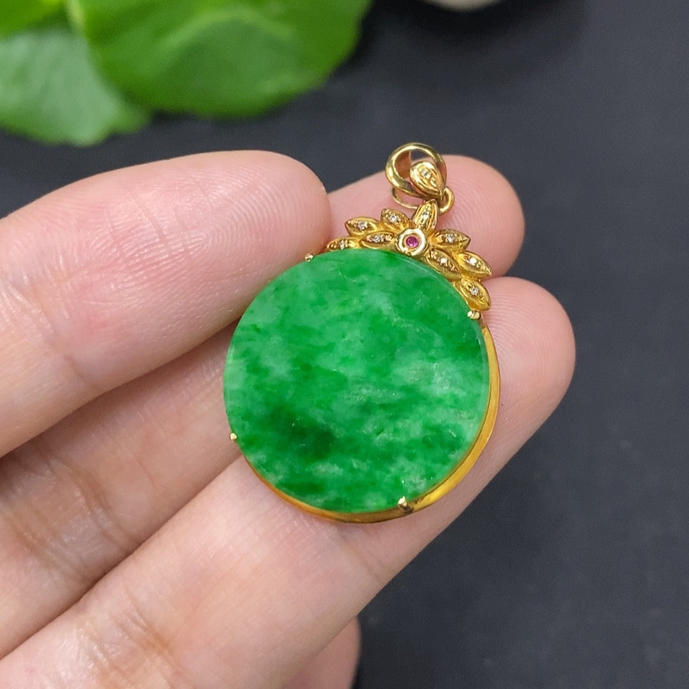 Jadeite plain pendant with 18K gold mount, featuring colorless diamond accents, on a delicate necklace chain.