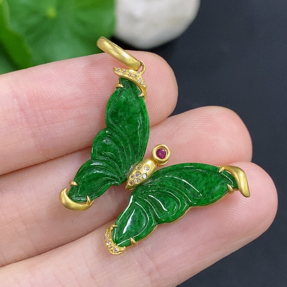 Jadeite pendant with 18k gold mount, accented with a colorless diamond, on a necklace chain, showcasing the jewelry's elegant design.