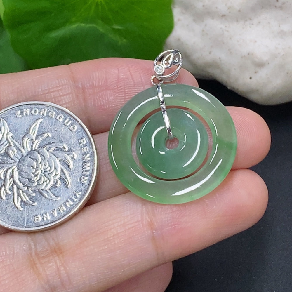 Jadeite mother-and-child button pendant with 18K gold and diamond accents, featuring a smooth jade surface and detailed design.
