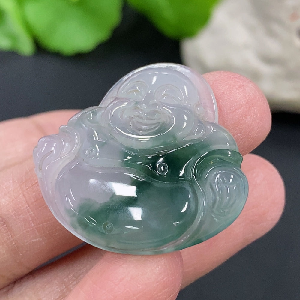 Green jadeite Buddha pendant with carved details, hanging on a cord, showcasing a smooth, polished finish.