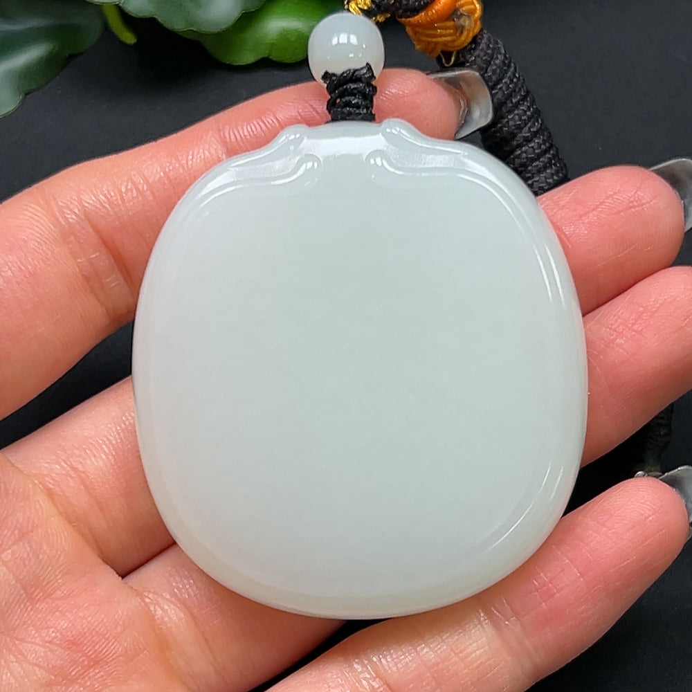 HKHQ Hetian jade plain pendant with rope, weighing approximately 64.08g, showcasing smooth, polished jade in a natural finish.