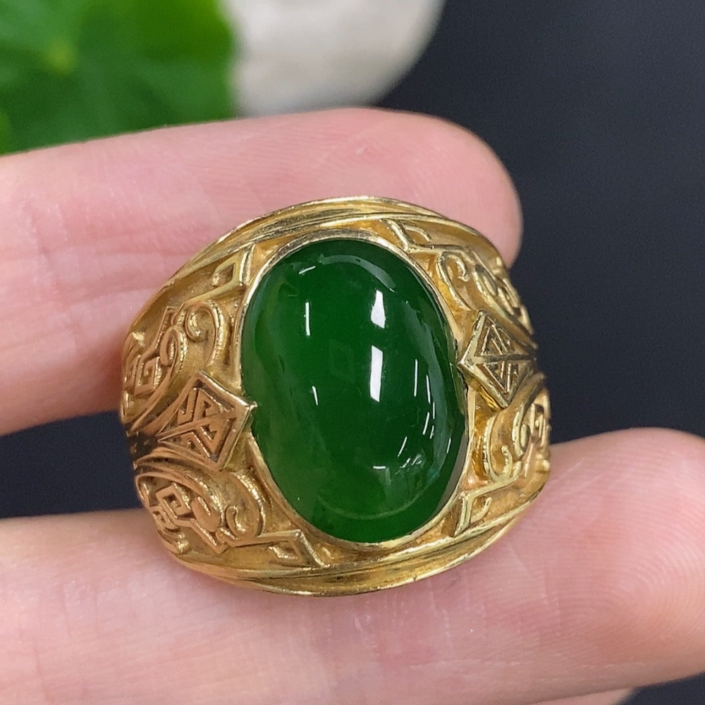 Elegant jadeite cabochon ring set in 18K gold, showcasing a smooth, polished green gemstone on a delicate gold band.