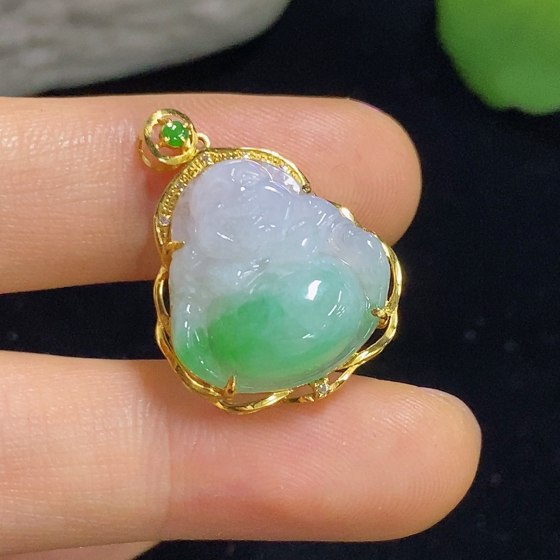Jadeite Buddha pendant with diamond accents in 18K gold, featuring intricate inlay and detailed craftsmanship.