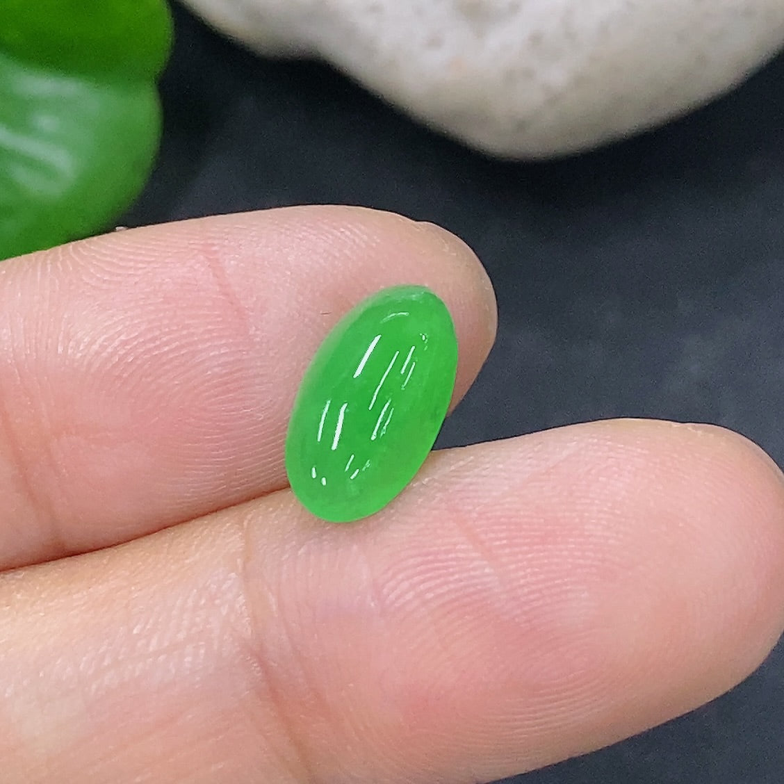 HKHQ jadeite cabochon jewelry piece, 0.43g, showcasing smooth, polished green jadeite with a glossy finish.