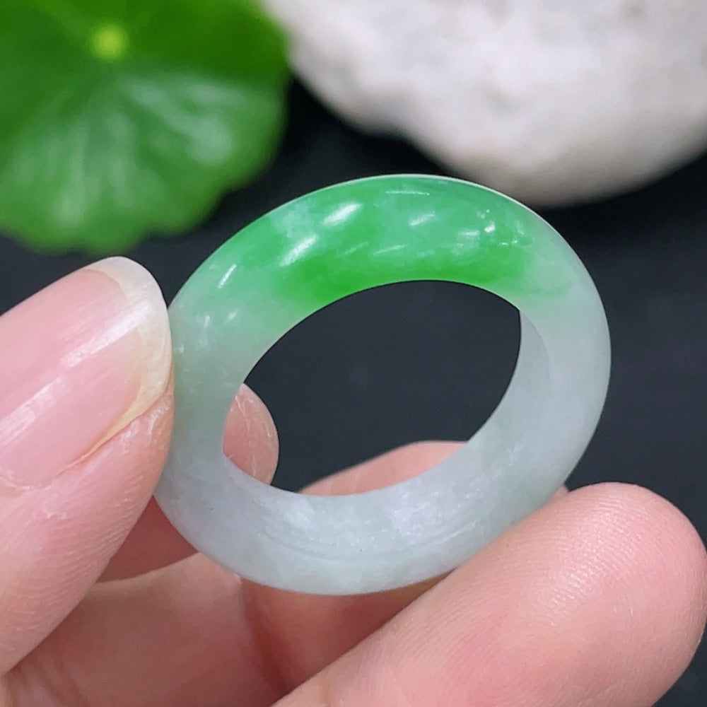 Unpolished jadeite ring in size 17.5 from HKHQ, showing its natural green color and smooth, unrefined surface.