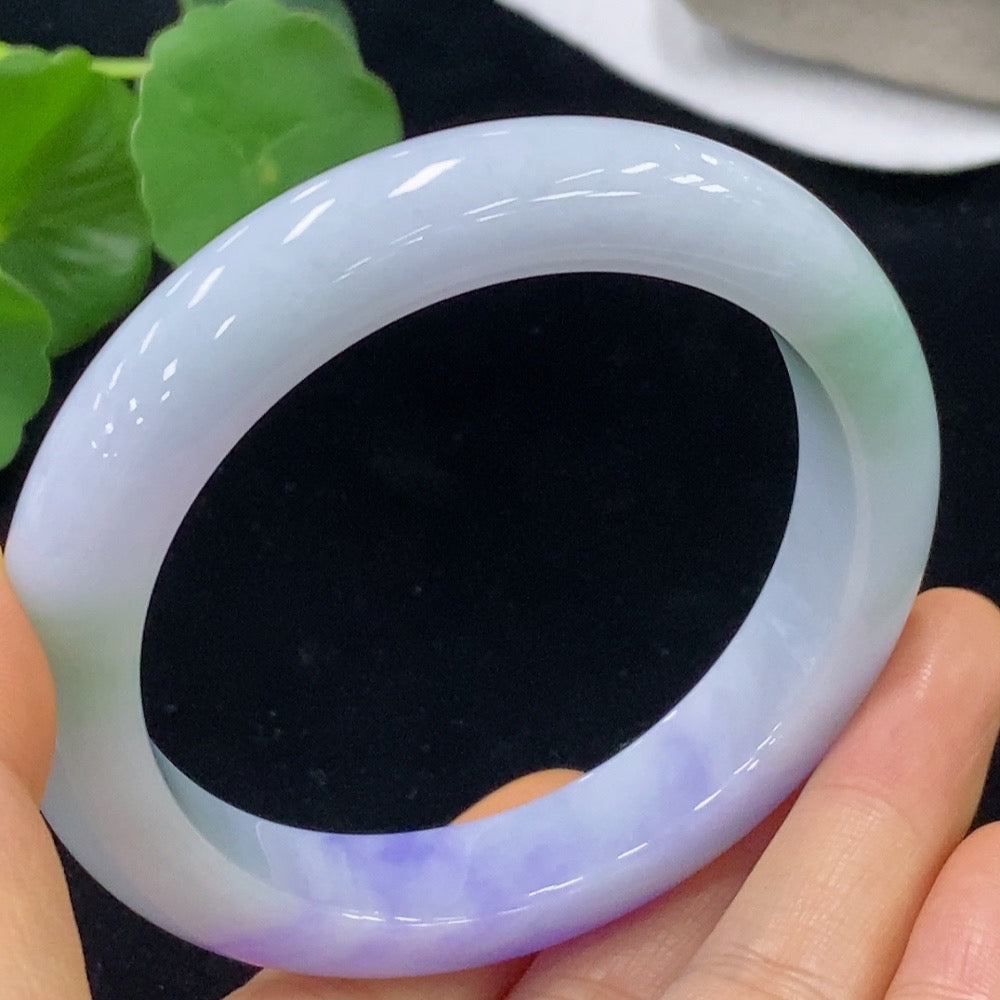 Jadeite bangle in size 59.3, weighing approximately 70.2g, crafted by HKHQ, showcasing smooth, polished jade surface.
