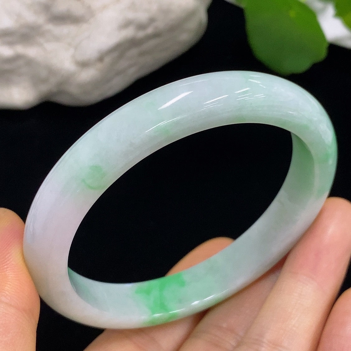Jadeite round bangle with 57.3mm size, crafted by HKHQ, showcasing smooth, polished green jade surface and elegant circular design.