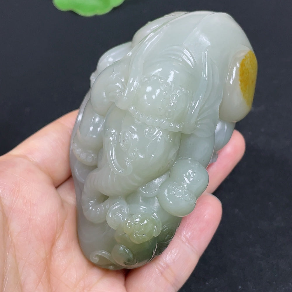 Close-up of HKHQ Hetian Jade Seed Material hand piece showcasing smooth, polished jade with intricate craftsmanship.