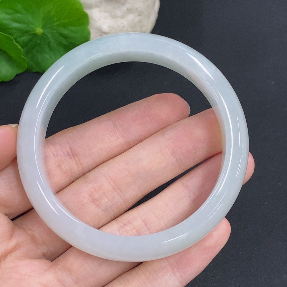 HKHQ jadeite round bangle weighing 52.7g, size 55.7, showcasing smooth, polished jade surface and elegant circular design.