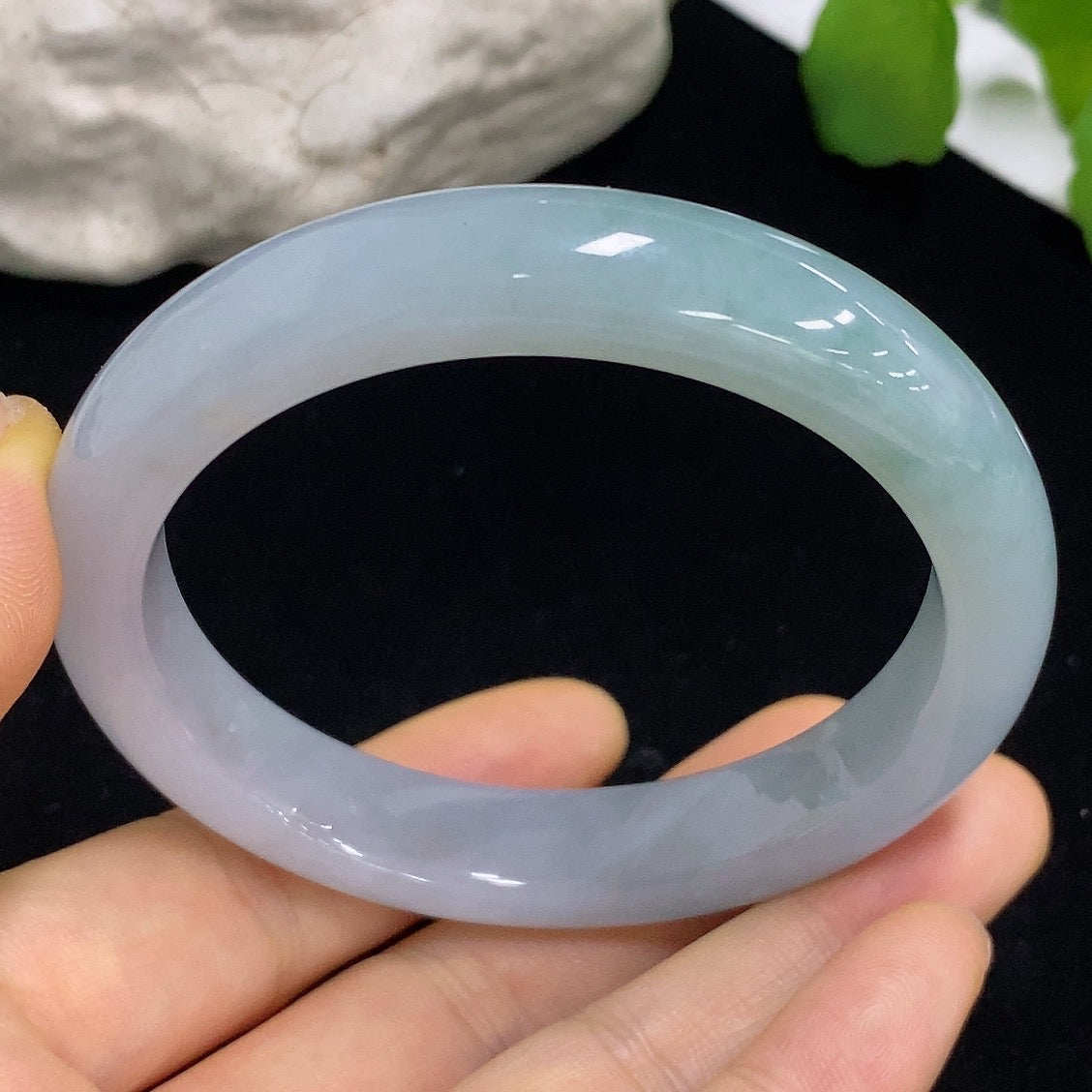 Jadeite round bangle in size 57.5 with a total weight of 57.64g, showcasing smooth, polished jadeite on a plain background.