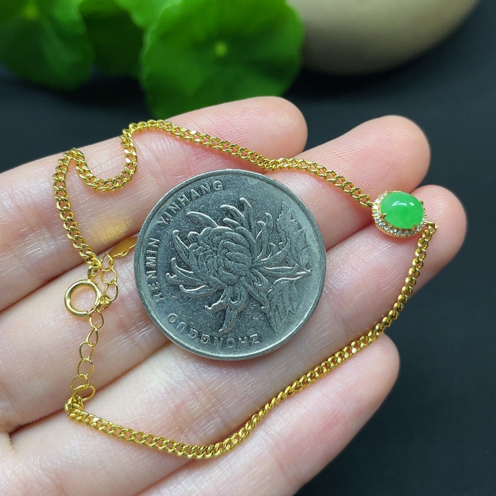 Jadeite cabochon bracelet by HKHQ featuring 18K gold setting with diamond accents, showcasing elegant jewelry design.