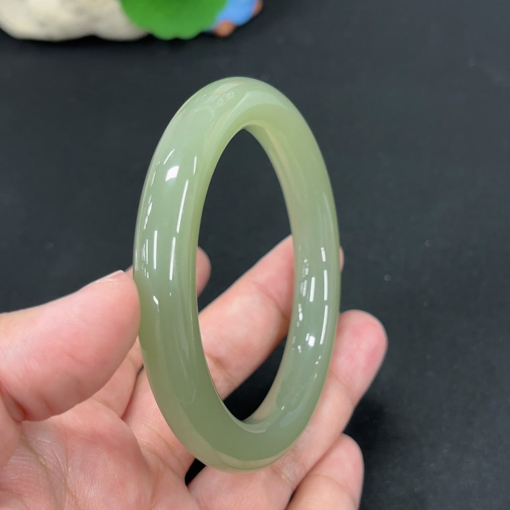 HKHQ Hetian Jade round bangle, size 56.9, weighs approx. 49.3g, showcasing smooth, polished green jade with a glossy finish.