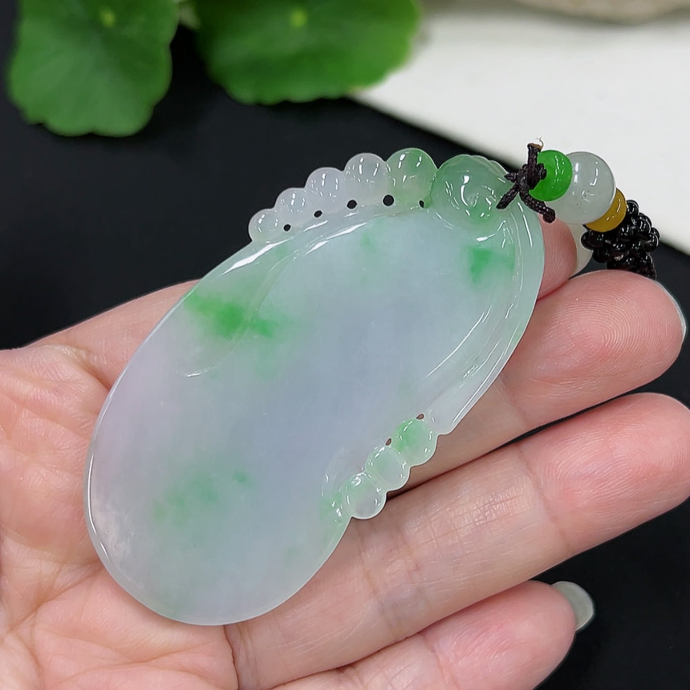 Jadeite goldfish pendant with gold accents, crafted from green jade, hanging on a rope, weighing approximately 30.5 grams.