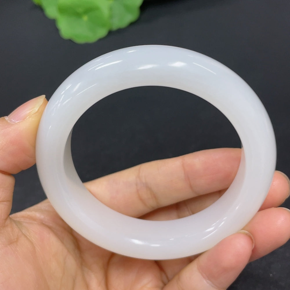 Round Hetian jade bracelet in size 54, weighing approximately 66.6g, featuring smooth, polished green jade beads by HKHQ.