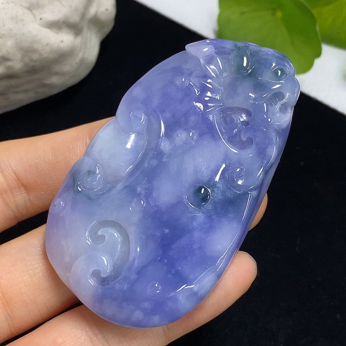 Jadeite Ruyi pendant with intricate carvings, weighing approximately 60.49g, showcasing smooth green jade craftsmanship.
