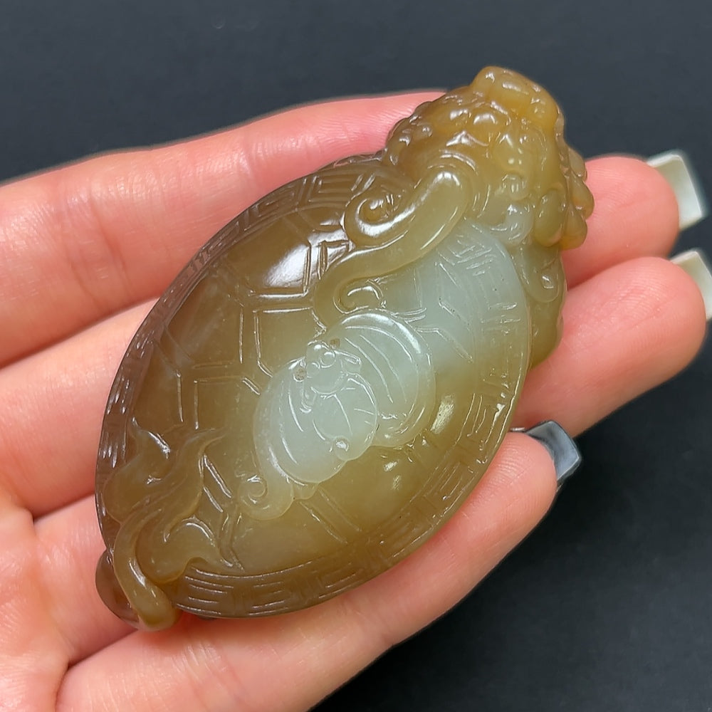 Hetian jade dragon turtle pendant from HKHQ, weighing approximately 54g, featuring intricate jade carving of a dragon and turtle design.