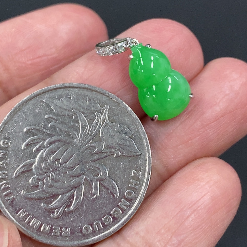 Jadeite gourd pendant with 18K gold and diamond accents, featuring intricate inlay work, weight approx. 1.47g.