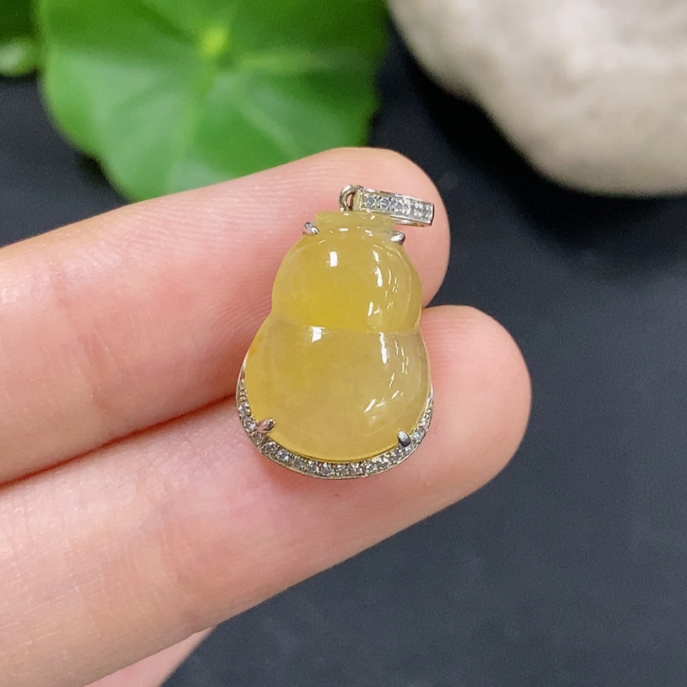 Jadeite gourd pendant with 18K gold and diamond inlays, showcasing a smooth, polished jade stone with gold bail and decorative details.
