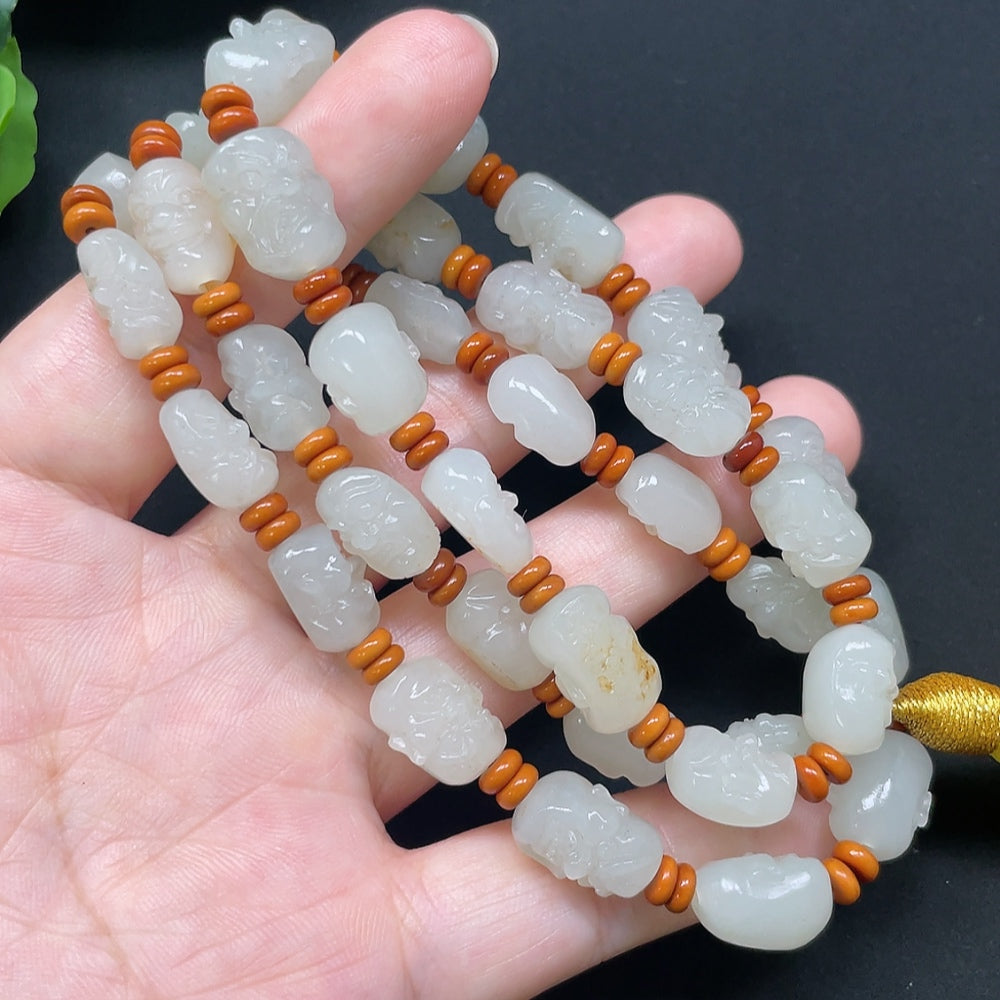 HKHQ Hetian Jade Eighteen Arhats bracelet with colorful beads and string, weighing approximately 65.71g, natural stone appearance.