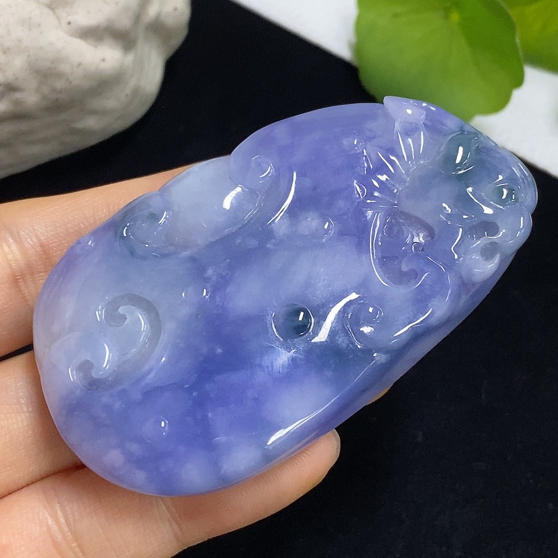 Jadeite Ruyi pendant with intricate carvings, weighing approximately 60.49g, showcasing smooth green jade from HKHQ.