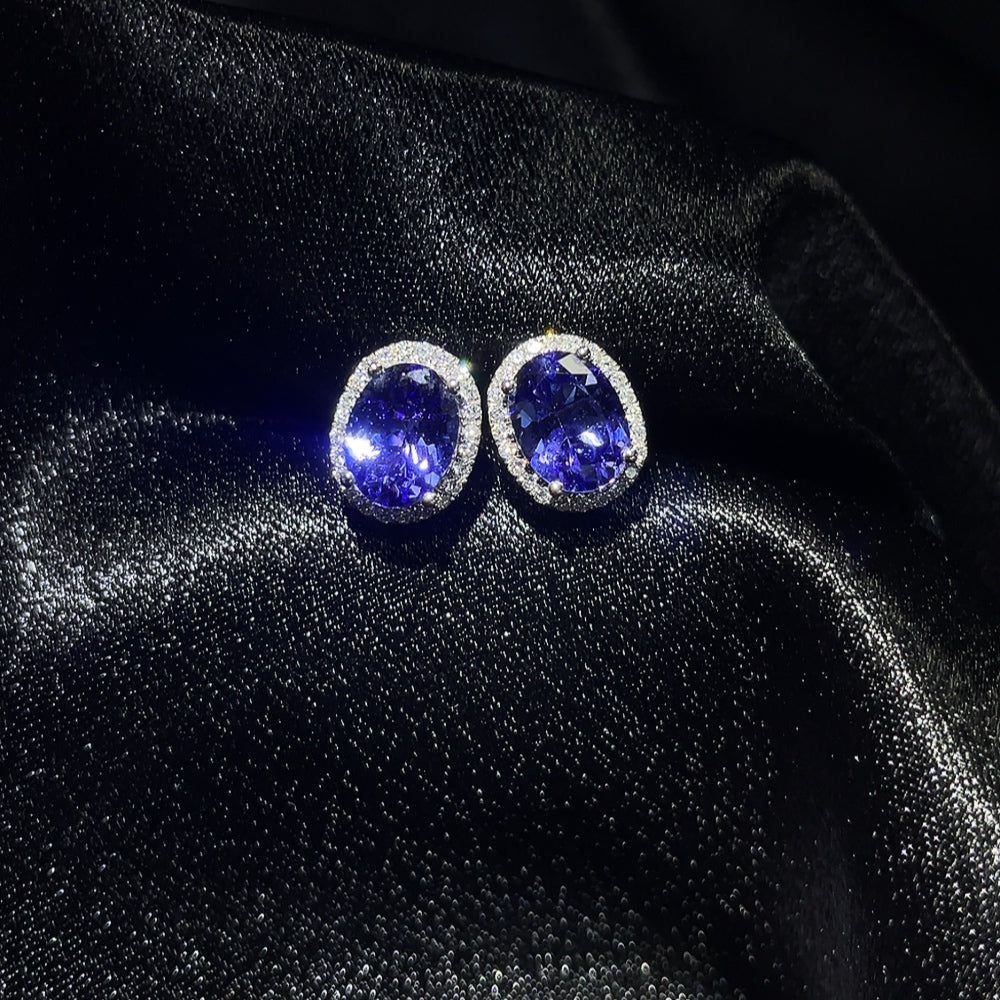 18K Tanzanite gemstone earrings with non-diamond accents, weighing approximately 2.25 grams, by HKHQ.