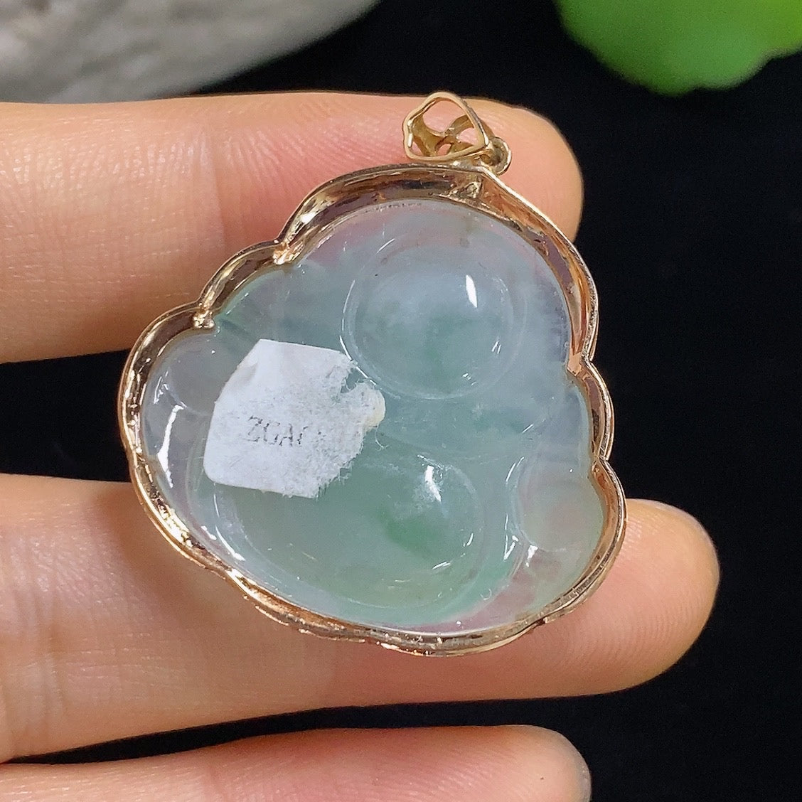 Jadeite Buddha pendant with 18k gold mounting, weighing approximately 6.31g, featuring intricate detailing and a polished finish.