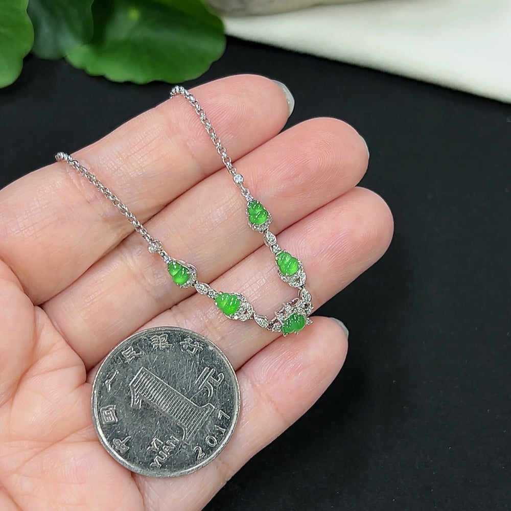 Jadeite gourd bracelet by HKHQ with 18k gold inlay and diamond accents, showcasing smooth jade with intricate detailing.