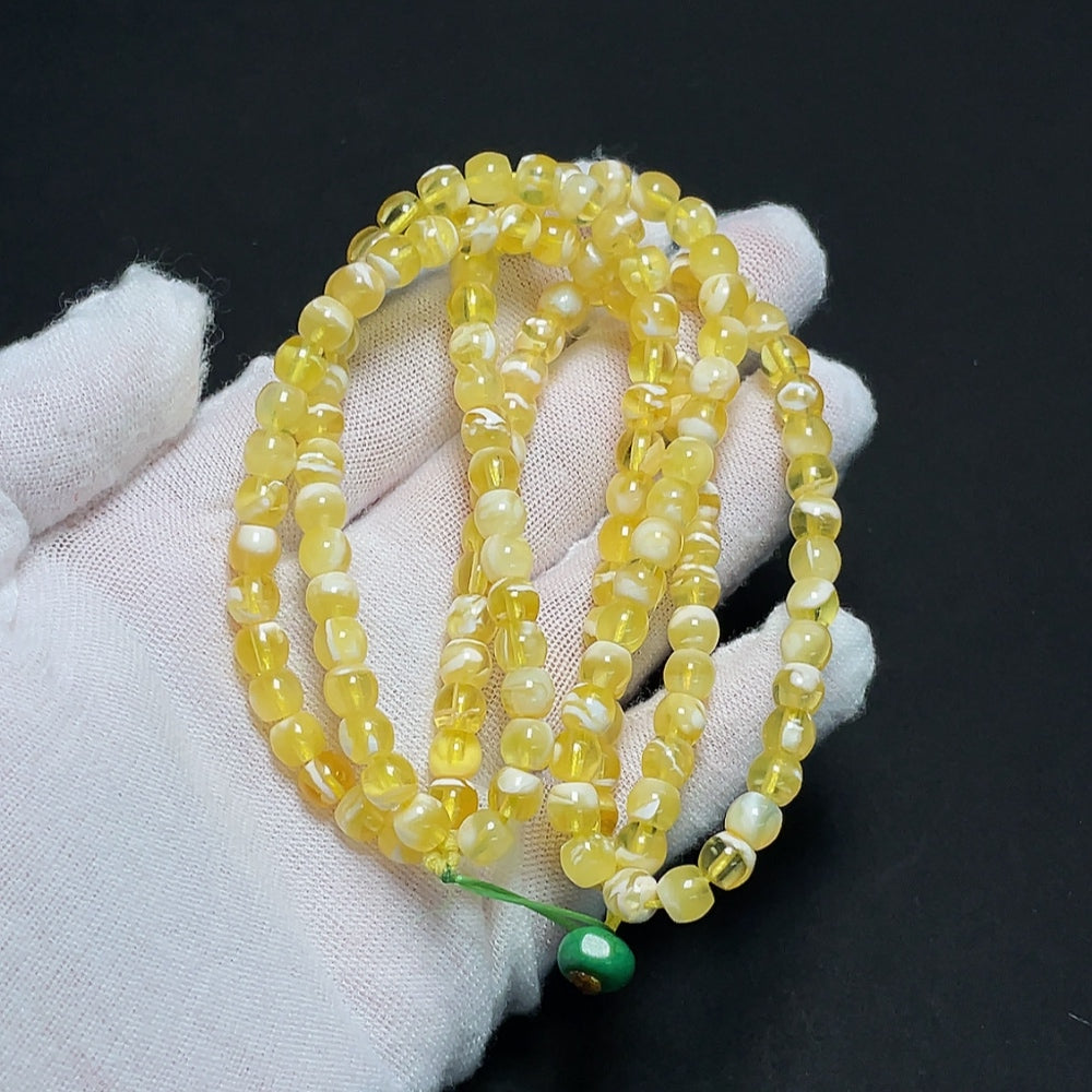 Amber beeswax bead strand with non-natural accent stones, 14.32g, 5.5mm size, showcasing HKHQ amber jewelry.