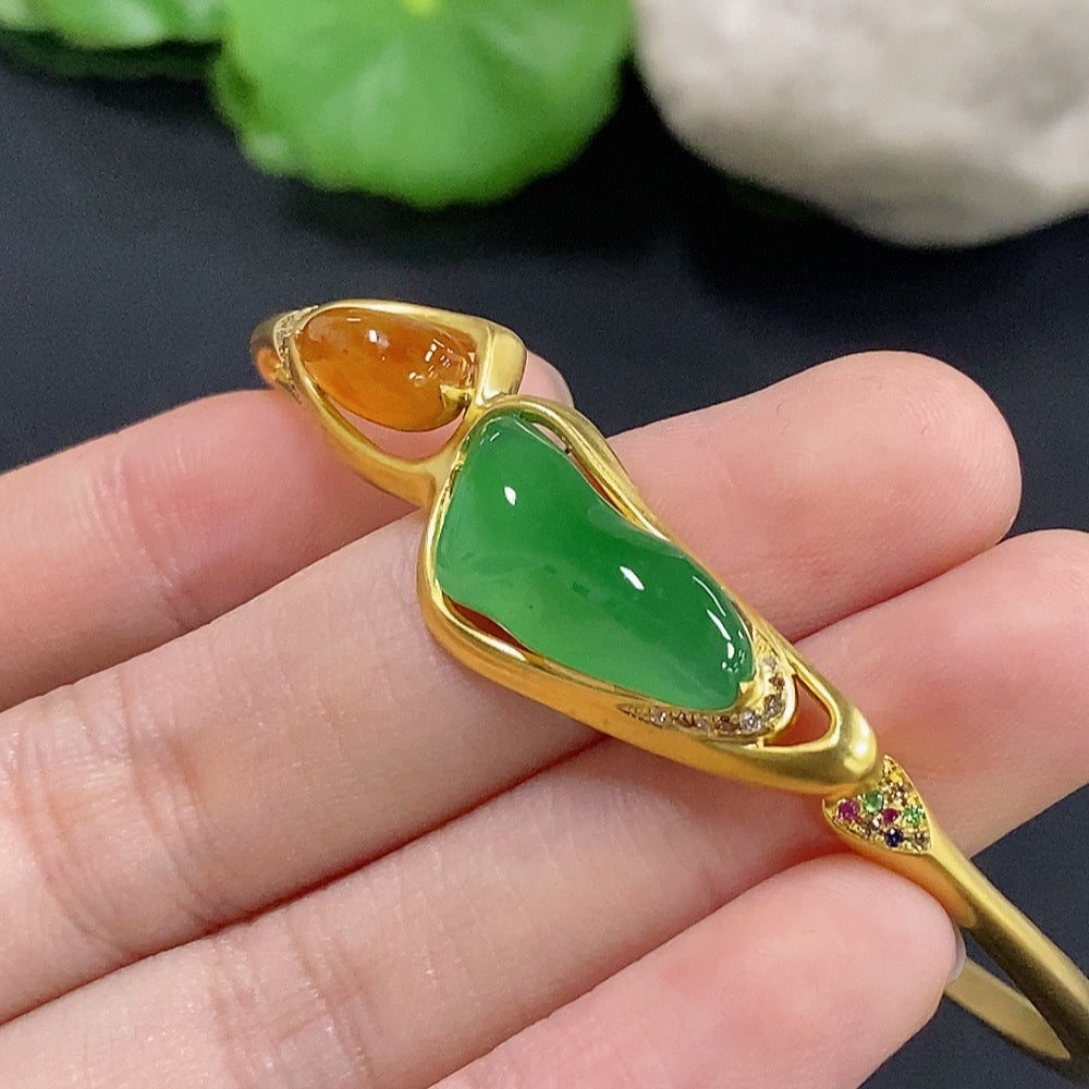 Jadeite inlaid bangle with 18k gold and diamond accents, HKHQ, showcasing intricate design and polished finish.