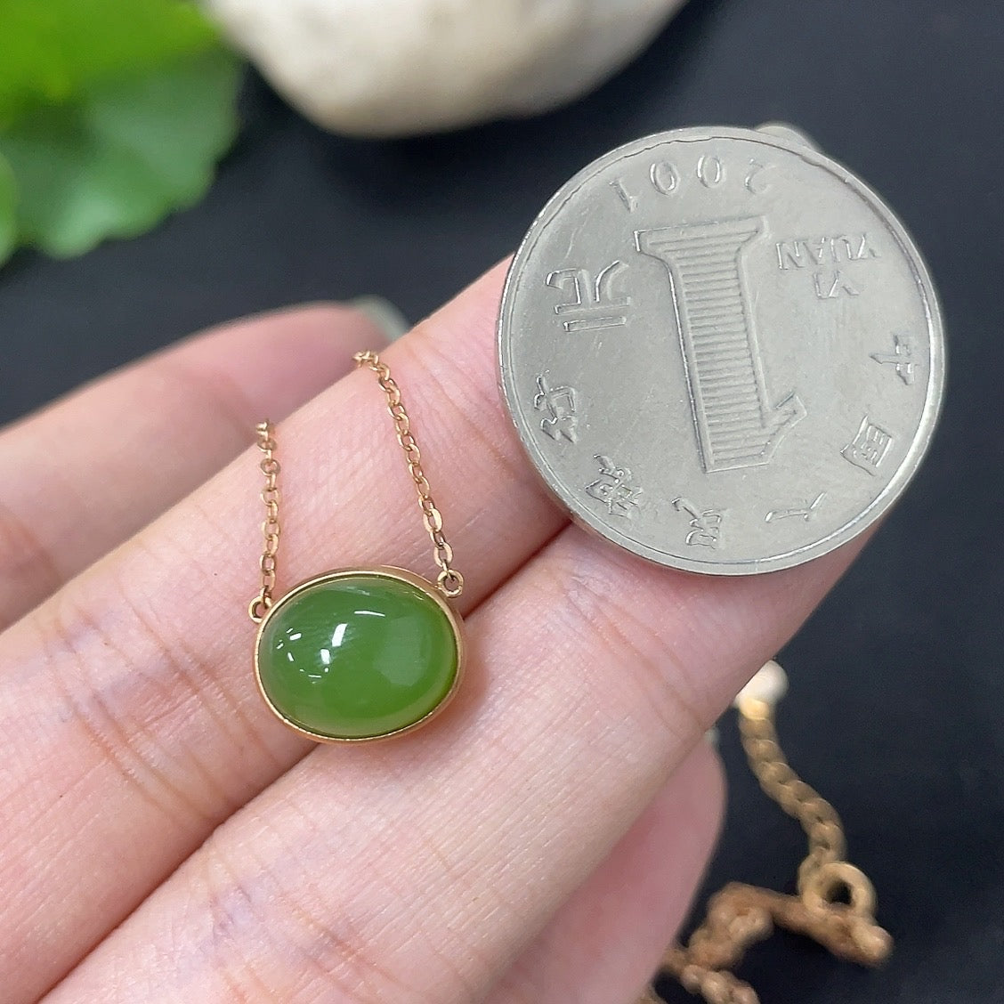 Hetian jade inlaid pendant with 18k gold setting on necklace, HKHQ brand, featuring a smooth jade stone and elegant gold details