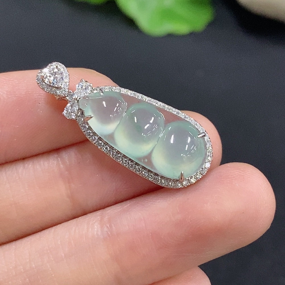 Jadeite lucky bean pendant with inlaid design, 18k gold, from HKHQ, showcasing detailed craftsmanship and smooth green jade surface.