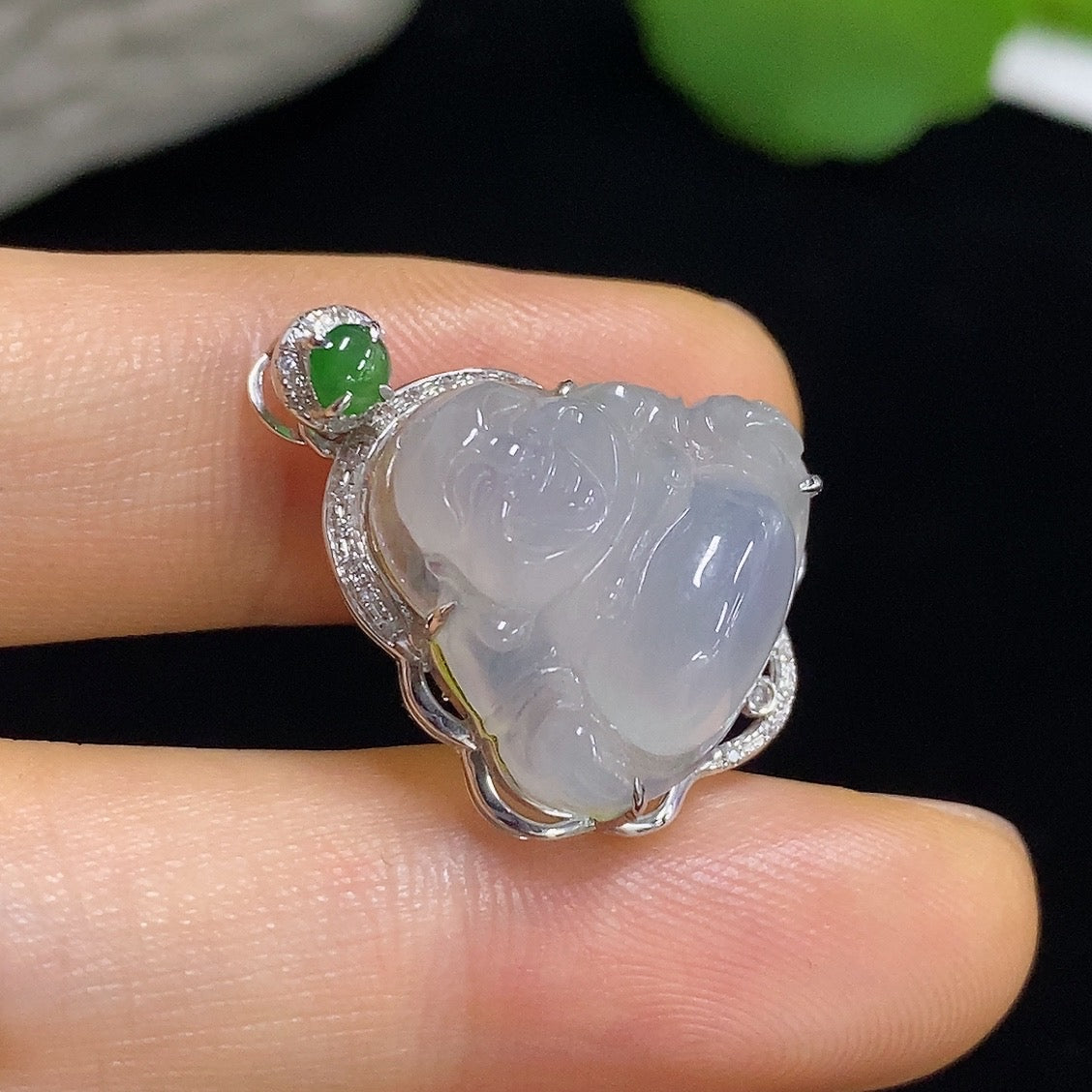 Jadeite Buddha pendant by HKHQ with 18k gold accents and diamond details, showcasing intricate craftsmanship and smooth jade surface.