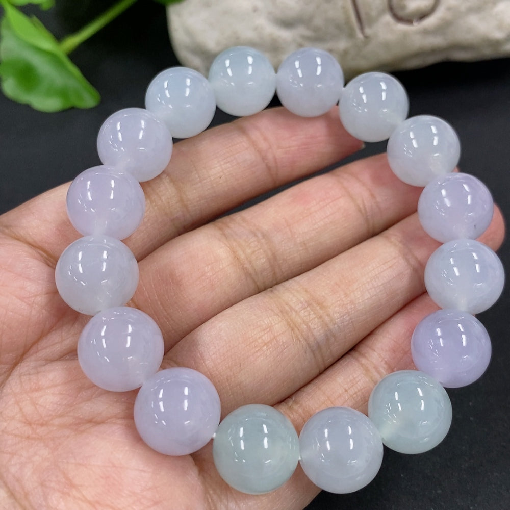 HKHQ jadeite bracelet with 12mm beads, weighing approximately 49.7g, showcasing smooth, polished green jadeite stones.