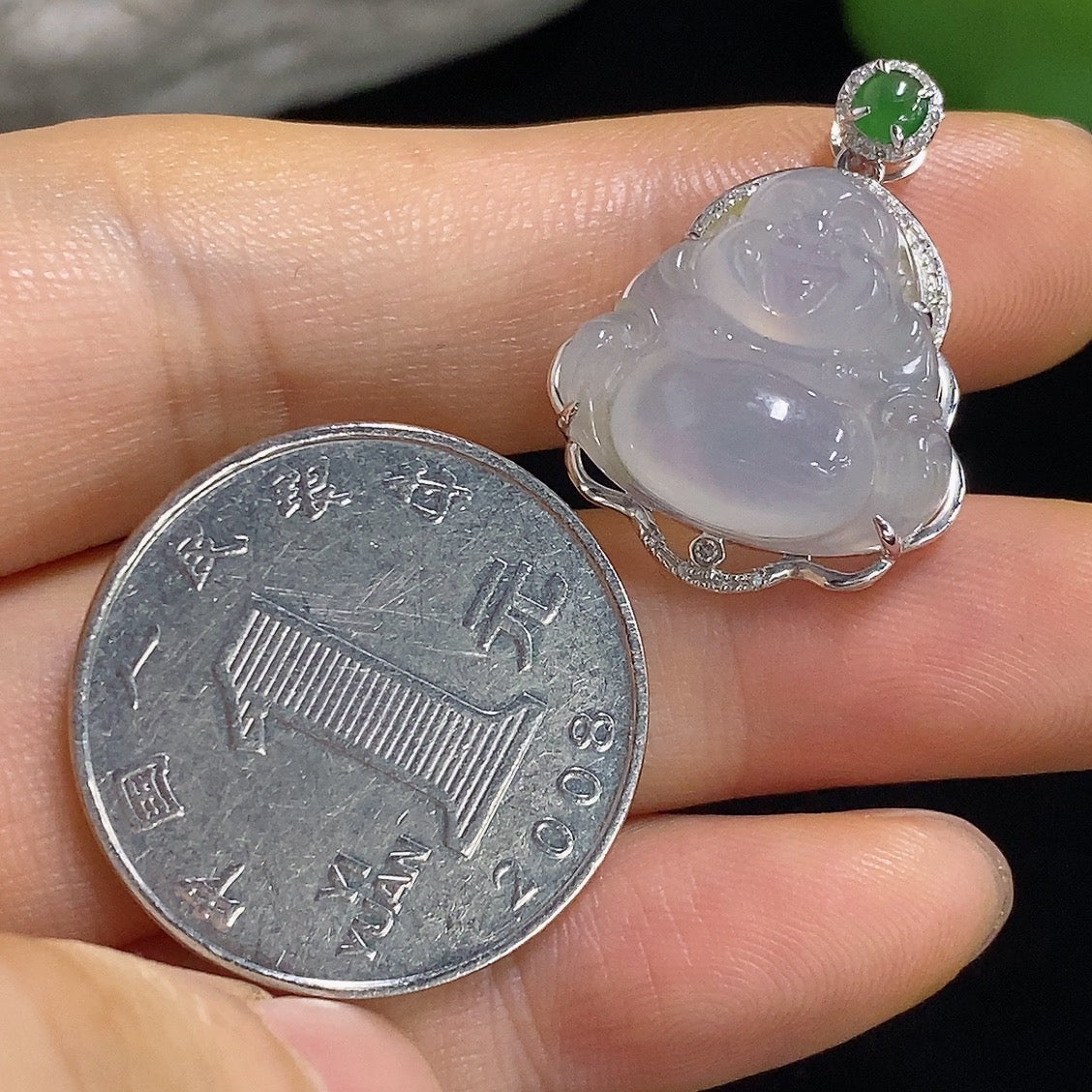 Jadeite Buddha pendant with 18k gold accents and diamond details, showcasing a detailed Buddha figure on a necklace.