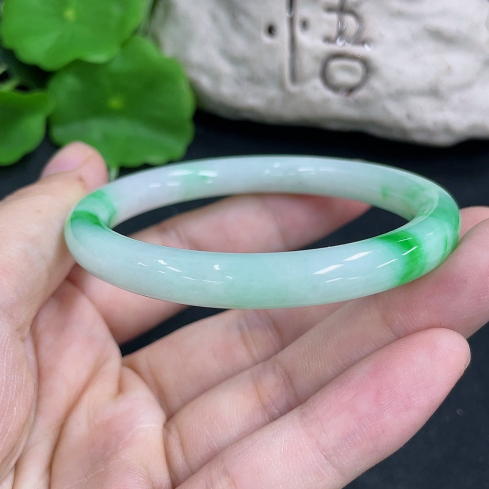 HKHQ jadeite oval bangle in size 54.2 with a weight of 25.8g, showcasing smooth, polished green jadeite bracelet.