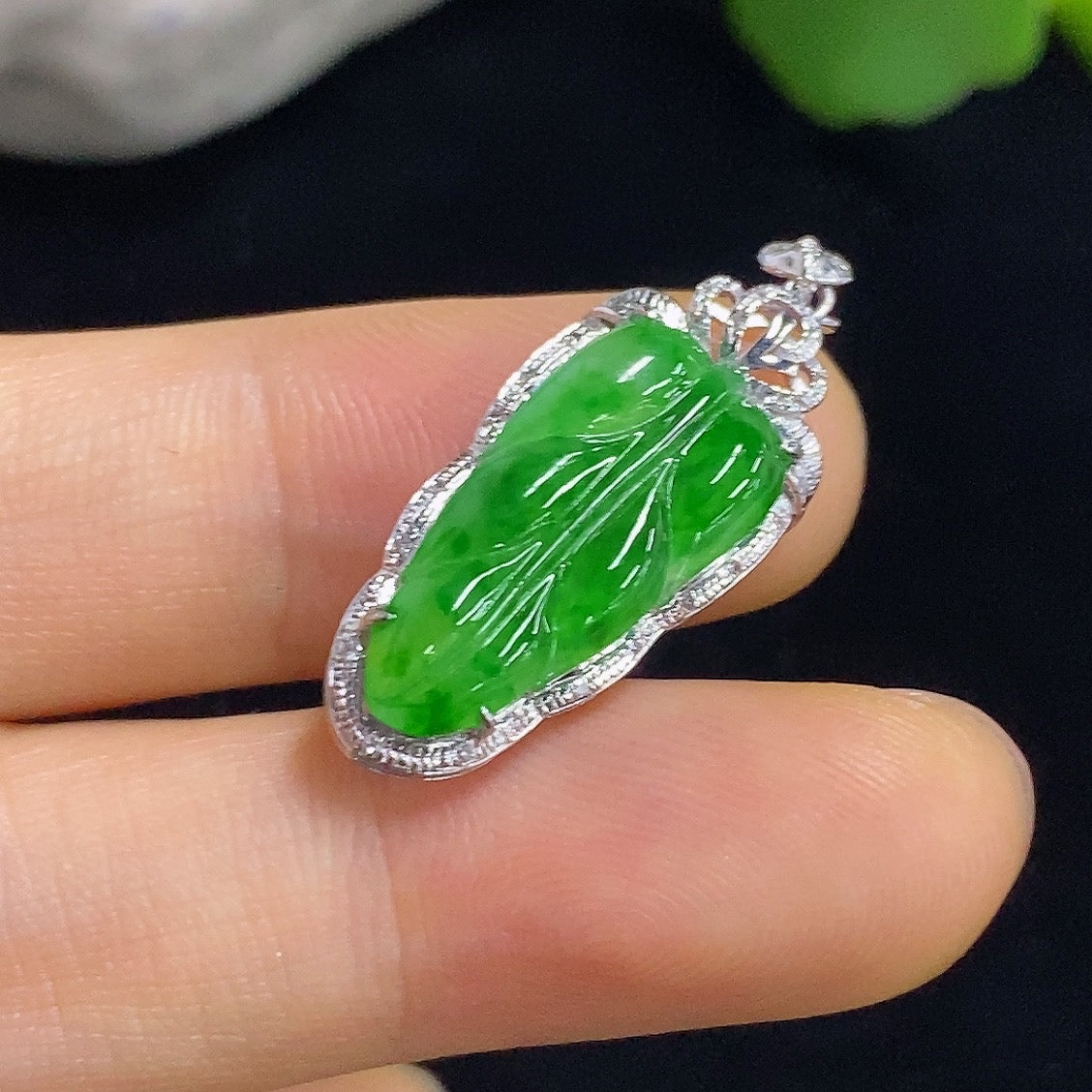 Jadeite leaf inlaid pendant with 18k gold and diamond accents, weighing approximately 2g, from HKHQ.