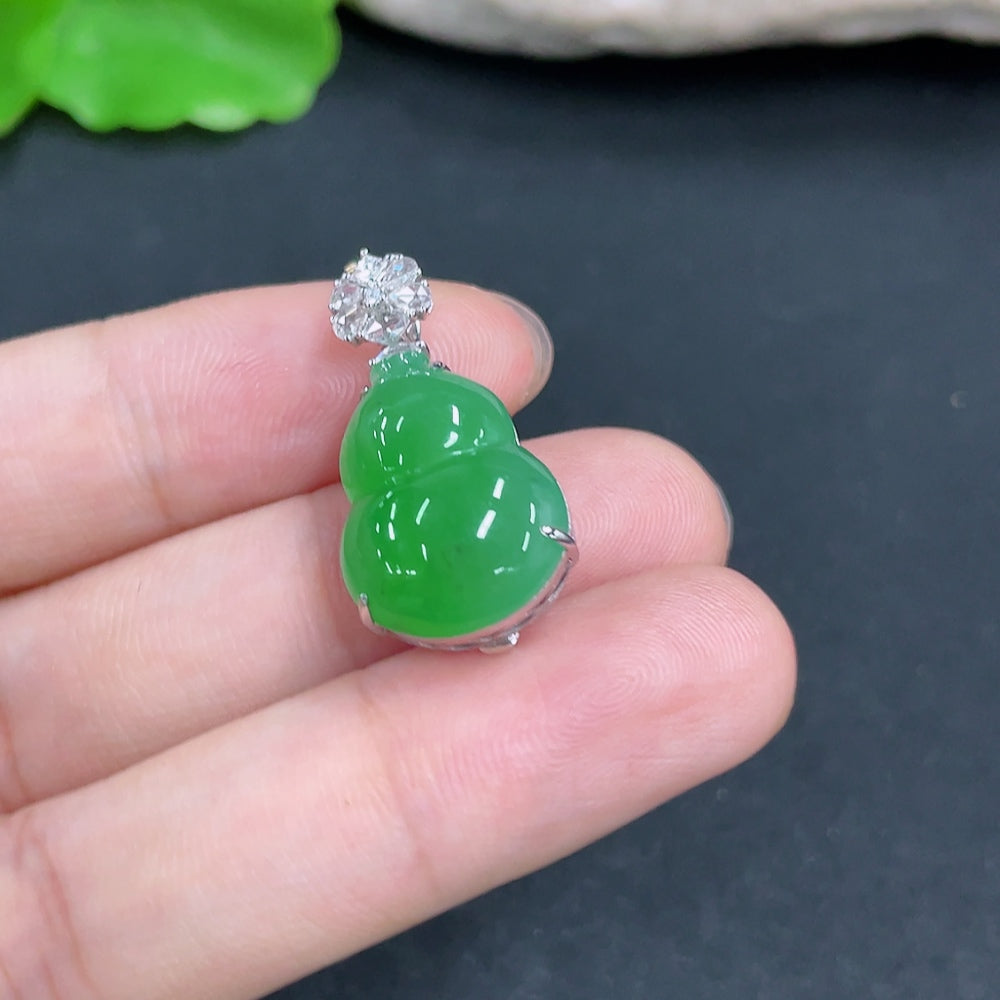 Jadeite gourd pendant with 18k gold and diamond inlays, showcasing detailed craftsmanship and a delicate chain.