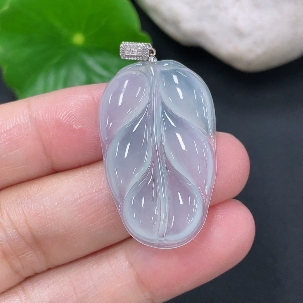 Jadeite pendant in leaf shape with 18k gold setting, weighing approximately 4g, showcasing a smooth, polished jade surface.