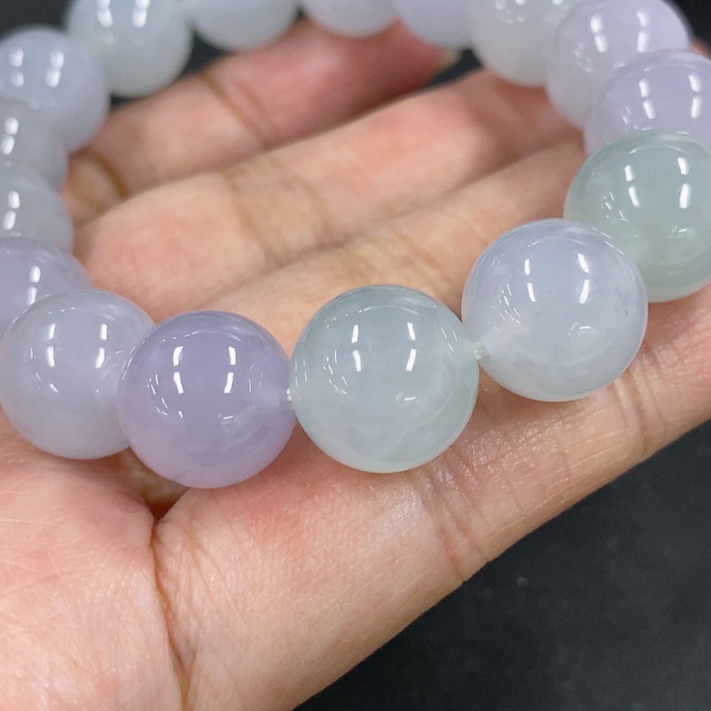 HKHQ jadeite bracelet featuring 12mm beads with a total weight of 49.7g, showcasing smooth, polished jadeite stones.