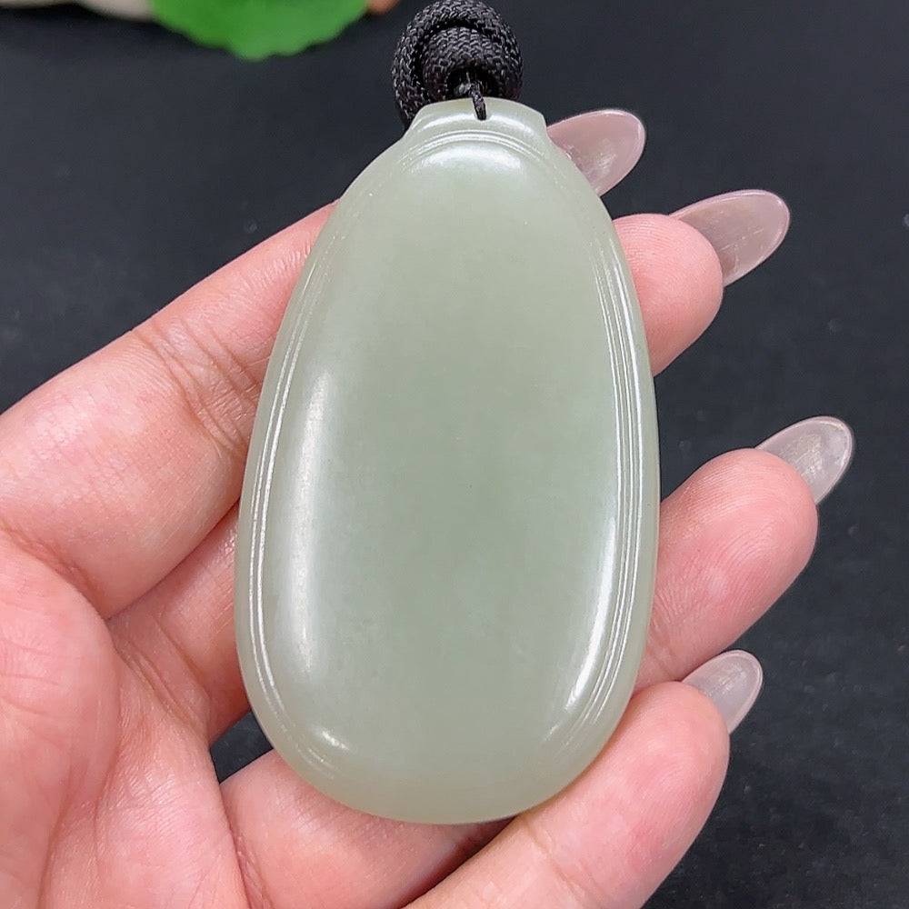 HKHQ Hetian Jade plain pendant with a smooth, polished surface, weighing approximately 55.6g, featuring a natural jade color.
