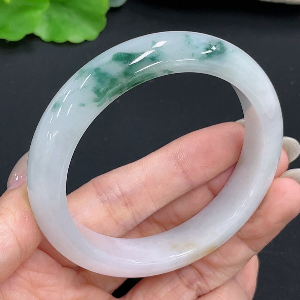 Jadeite round bangle with size 55.1 and weight 55.3g, crafted from green jade, displayed on a neutral background.