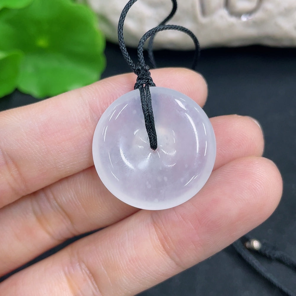 HKHQ jadeite pendant necklace showing a beautifully polished green jadeite gemstone on a delicate chain.