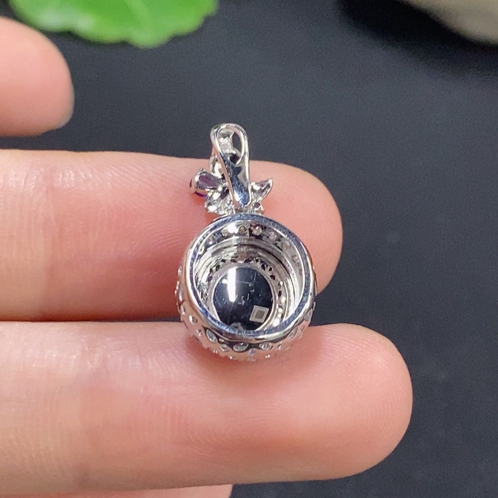Jadeite cabochon pendant with 18k gold setting and diamond accents, featuring a polished green jade gemstone.
