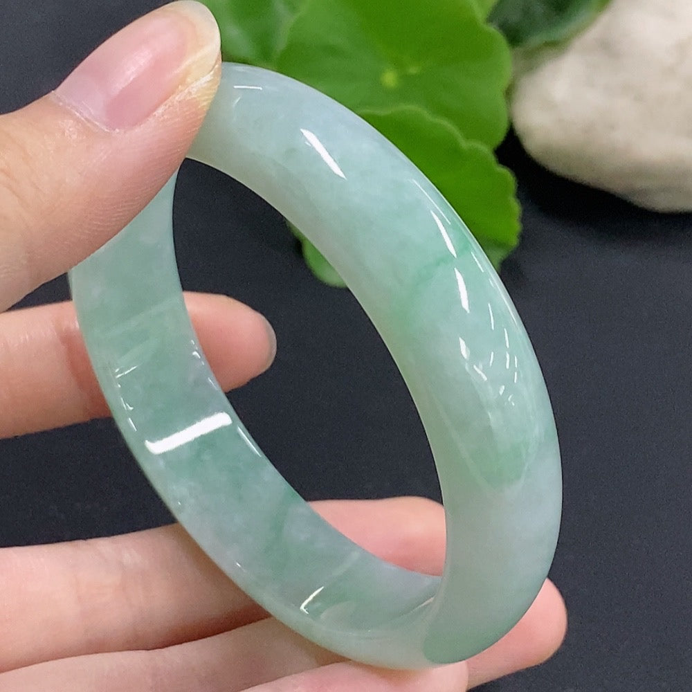 Jadeite round bangle by HKHQ featuring a smooth, polished surface and a size 57, weighing approximately 51.9 grams.