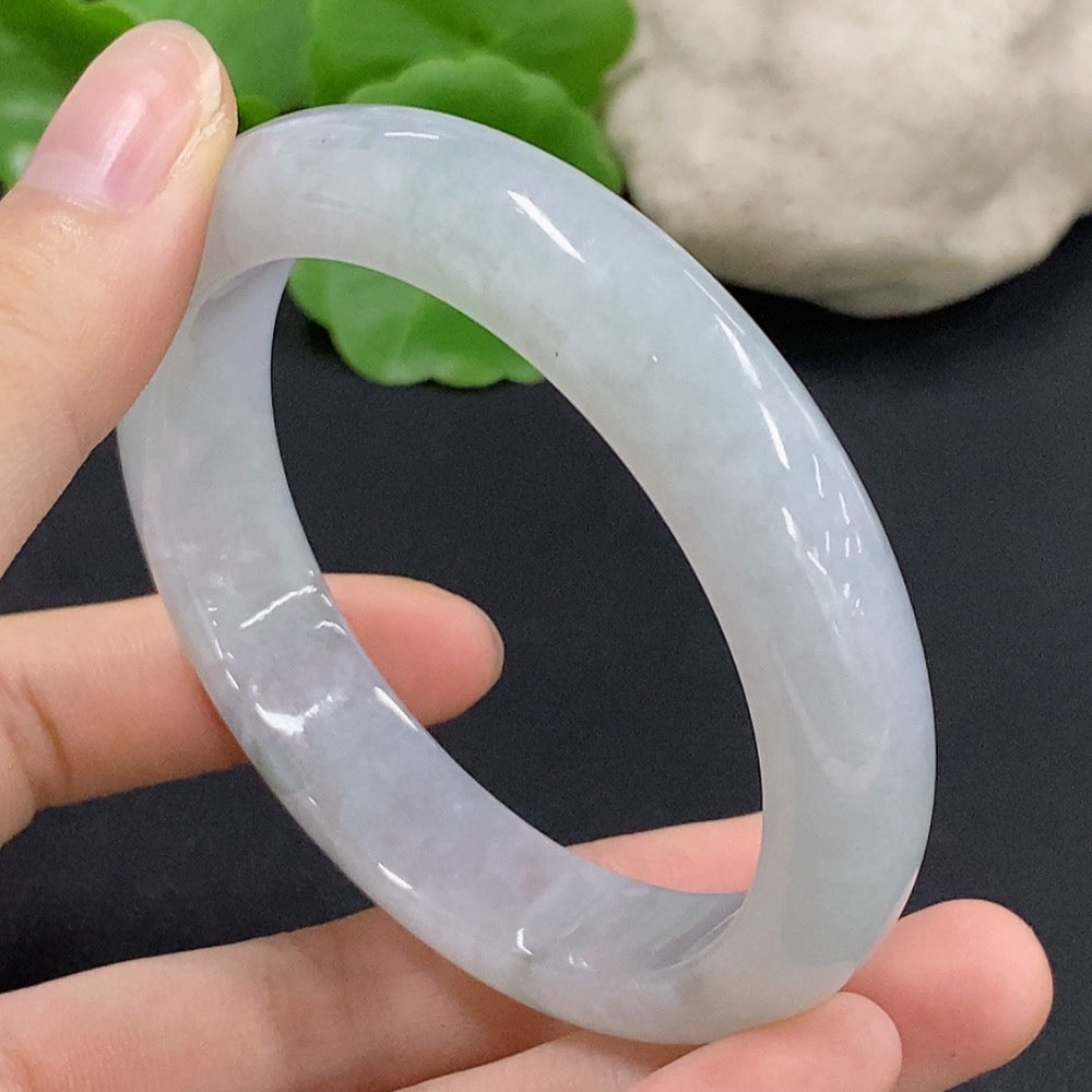 Jadeite round bangle in size 56.8, weighing approximately 58.92g, featuring smooth polished jade surface and vibrant green color.