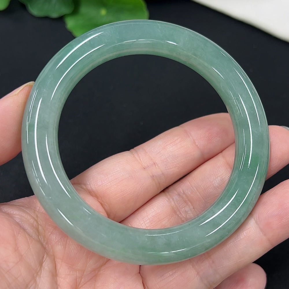 HKHQ jadeite round bangle, size 54.3, weighing approximately 58.4g, showcasing smooth, polished jade surface.