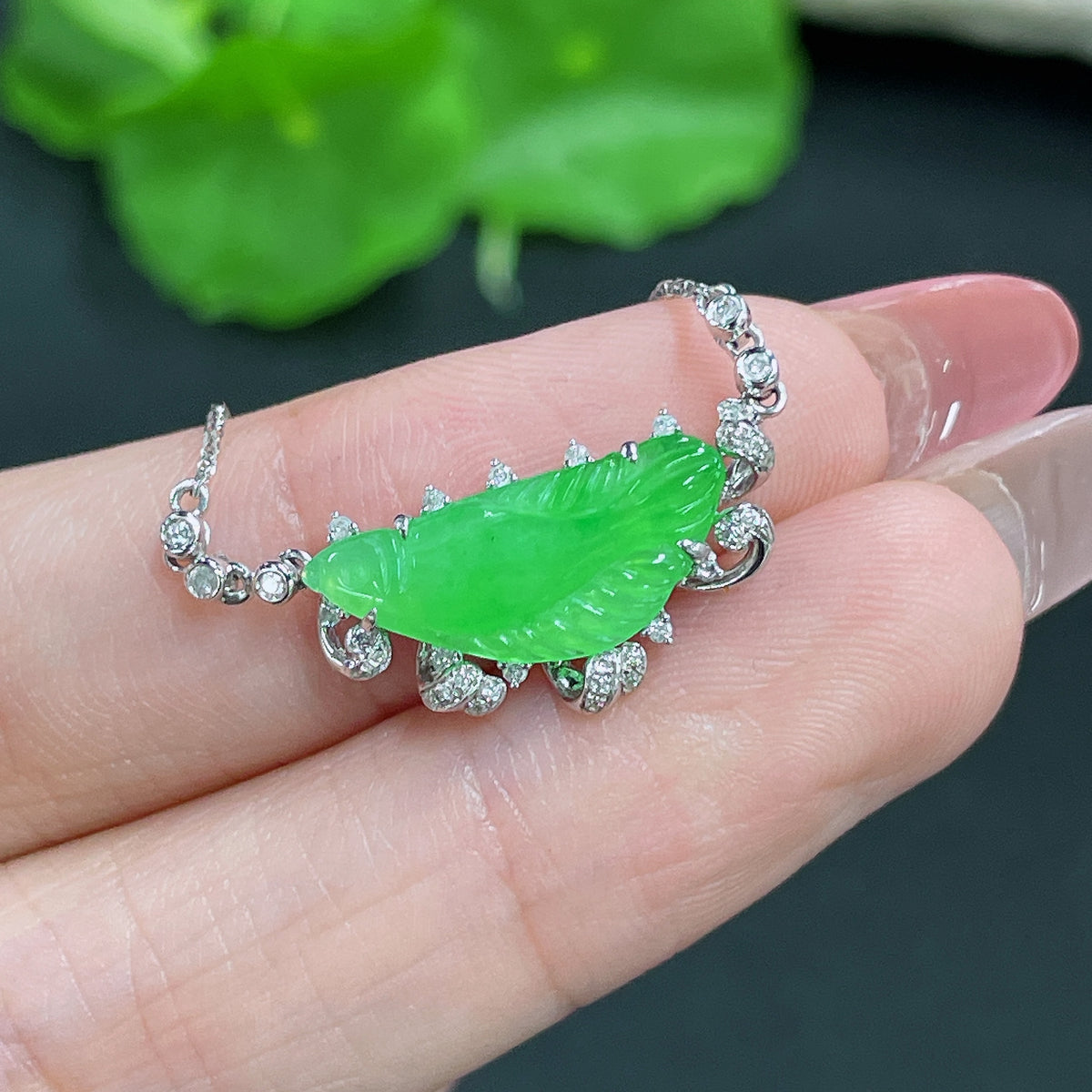 Jadeite pendant with 18k gold inlay and diamonds, attached to a chain, weighing approximately 2.61g, by HKHQ.