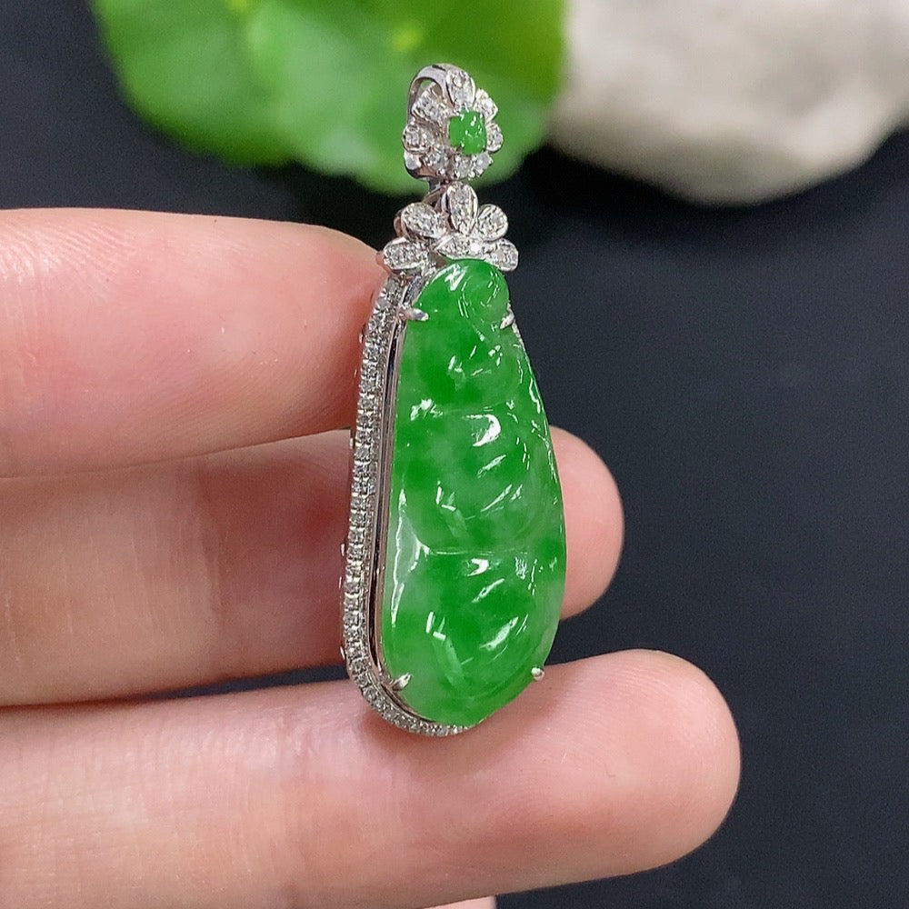 Jadeite bean inlay pendant with 18k gold setting and diamond accents, showcased on a jewelry display.
