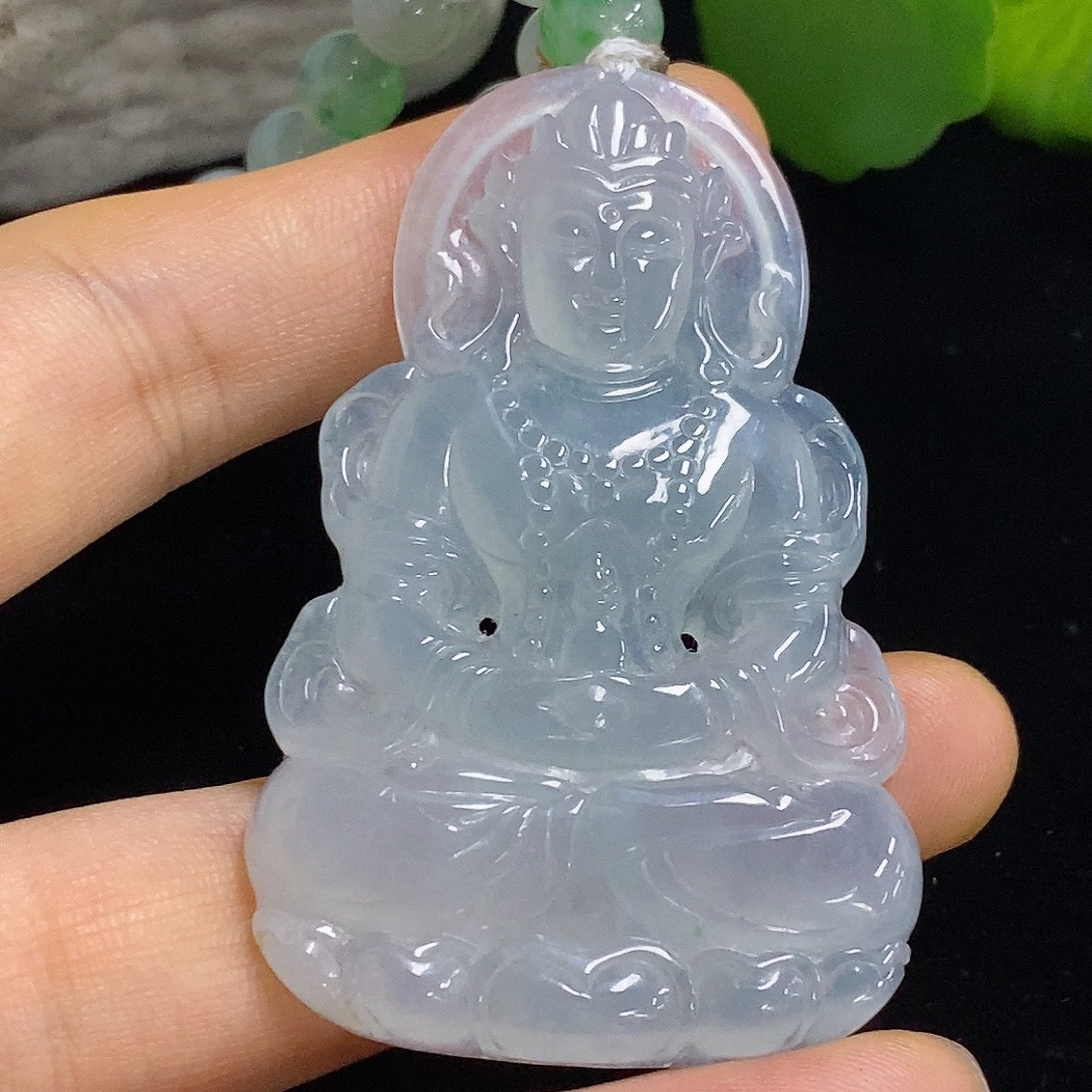 Jadeite Tara pendant from HKHQ, featuring a smooth, polished jade jadeite pendant with intricate carved details.